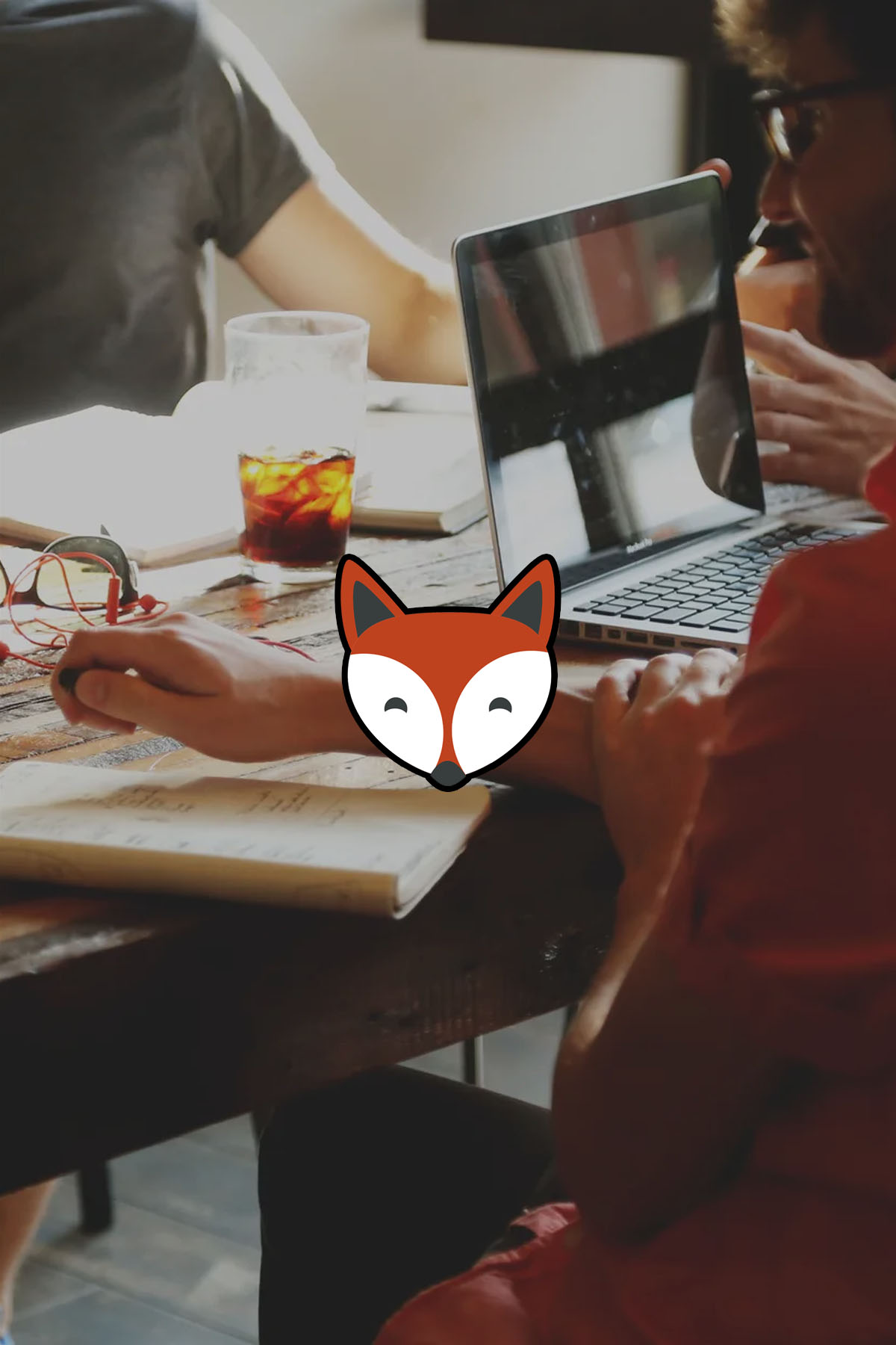Poste de travail : ordinateur portable, carnet et notes, avec le logo FoxVision.
